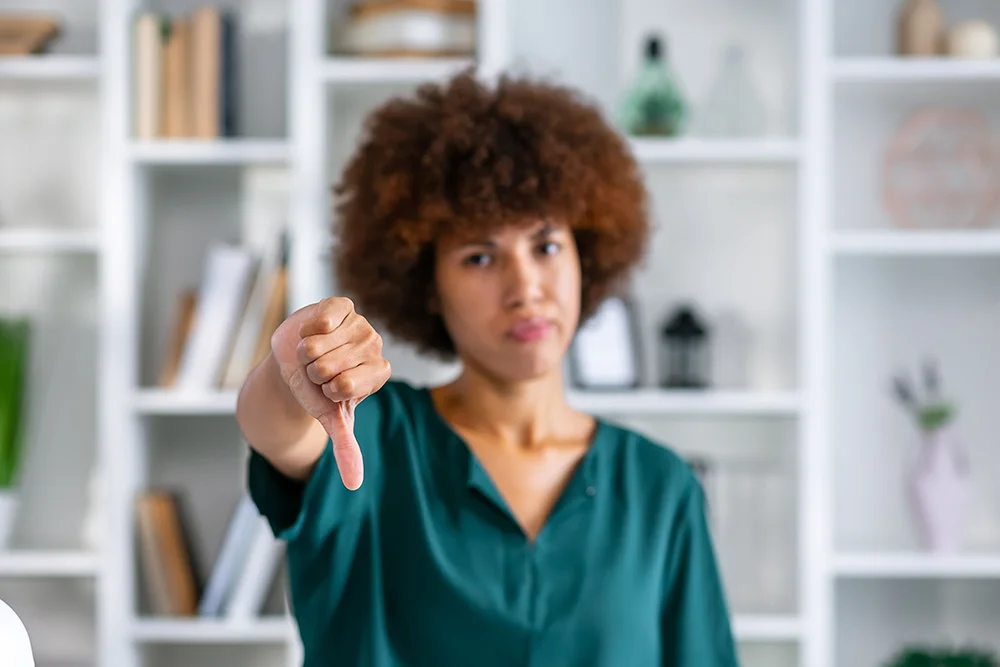 Frau zeigt den Daumen runter